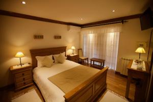 雷森迪Quinta de CasalMato的一间卧室设有一张大床、两盏灯和一个窗户。