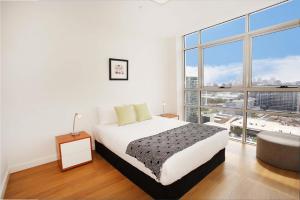 悉尼G1708S三卧室泽特蓝公寓的白色的卧室设有床和大窗户
