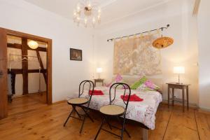 梅斯基希克洛斯特赫堡乡村民宿的一间卧室配有一张带两把椅子和两张桌子的床。