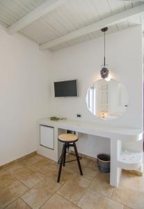 迈洛波塔斯卡特琳娜酒店的白色的厨房配有桌子和凳子
