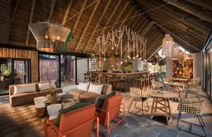 萨比沙禁猎区Lion Sands River Lodge的带沙发和椅子的客厅以及酒吧。