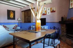 奥萨德蒙铁尔Casas Rurales Lagunas de Ruidera - Piscina的一间用餐室,配有一张桌子和花瓶