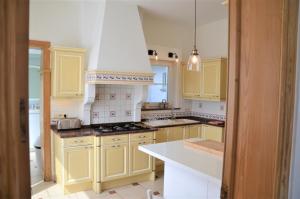 伊普尔Ciepers Lodge的厨房配有黄色橱柜和白色台面