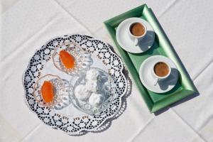 特尔斐Hermes Delphi Hotel的一张桌子,上面放着一盘食物和两杯咖啡