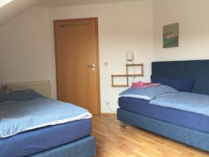 迪尔门Kleine Wohnung mit Terrasse的配有2张蓝色的床的带门的房间