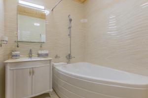 撒马尔罕拉尔加马科酒店的白色的浴室设有浴缸和水槽。