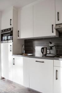 海牙Haags Duinhuis - familyfriendly holidayhome的白色的厨房配有白色橱柜和电器
