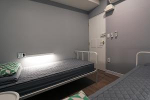 釜山海云台蓝舟旅舍的一间小房间,内设两张床
