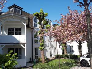宾茨Atelier-Appartement Ambienta im Zentrum von Binz的前面有树木的白色房子