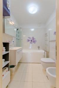 苏佩塔尔Apartment Villa Camellia - Adults Only的白色的浴室设有浴缸、卫生间和水槽。