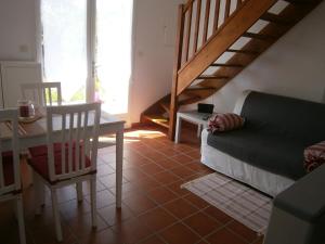 卡尔萨克阿亚克La Chenillette的带沙发、桌子和楼梯的客厅