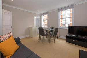 伦敦One bedroom High street kensington Apartment的客厅配有沙发和桌椅