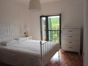 卡马里尼亚斯Xaviña Camariñas的白色的卧室设有床和窗户
