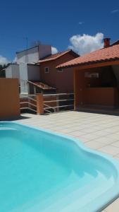 塞古罗港Guest House Paraiso Pataxos的房子前面的蓝色游泳池
