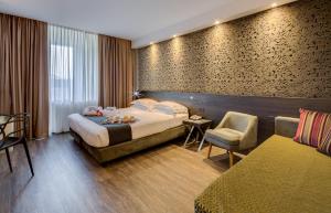 法尔内塞加贝斯特韦斯特优质酒店客房内的一张或多张床位