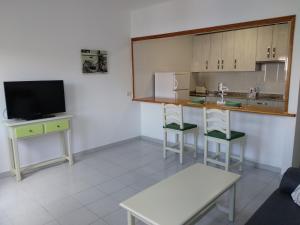 阿雷西费Apartamento Malvasía Vv的客房设有带柜台的厨房和电视。