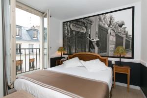 巴黎阿特利尔瓦万酒店的一间卧室设有一张床和一个大窗户