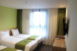 首尔库雷塔克索因萨东酒店的酒店客房设有两张床和窗户。