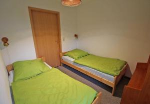巴特Ferienwohnung Barth VORP 431的配有绿床单的客房内的两张床