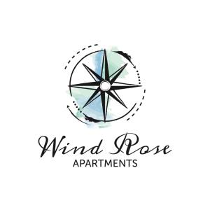 托尔博莱Wind Rose Apartments的带有罗盘的风罗公寓大楼的标志