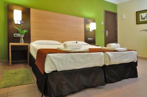 马德里巴耶斯塔旅馆的酒店客房,配有两张带毛巾的床