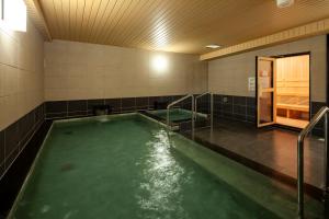 那霸那霸可库西街胶囊旅馆 的浴室里设有一个绿色的游泳池