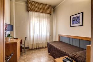 佛罗伦萨德拉纳泽欧尼酒店的一间卧室配有一张床和一张带电脑的书桌