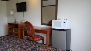 克林顿港Stay Inn的酒店客房配有书桌、床和镜子