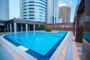 拉布安贝塔服务式公寓酒店的一座位于城市的游泳池,有高大的建筑