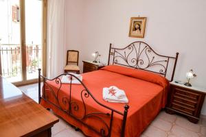 马里迪莫Casa Noto的一间卧室配有一张带红色毯子和桌子的床。