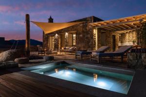 法蒂亚Mykonos AG Villas的夜间带游泳池的别墅