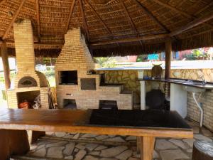 阿瓜斯-迪圣佩德罗Pousada Rural Paraíso的砖壁炉前的木桌
