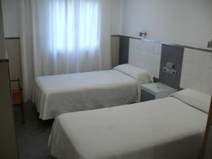 马拉加拉河斯派德旅馆的酒店客房设有两张床和窗户。