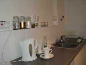 斯托克波特梅普尔旅馆的厨房柜台设有水槽和2个咖啡杯