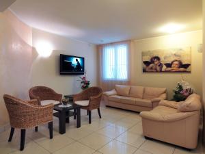 里米尼Hotel Ombretta Mare的客厅配有沙发和桌椅