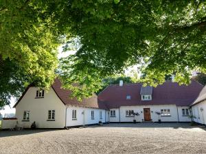 奥特鲁普Apartment in Danmark- Agernaesgaard Otterup的一座白色的大建筑,有红色的屋顶