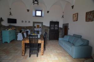 维泰博Magica Torre Medievale的客厅配有桌子和蓝色沙发