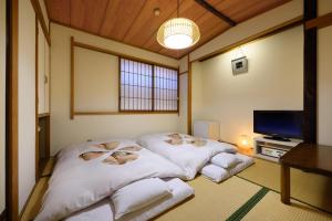 Hotel Sakuranbo客房内的一张或多张床位