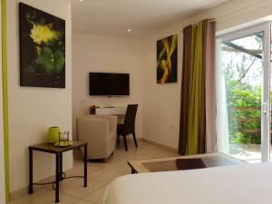 维琪奥港Private Hôtel - Adult Only的一间卧室配有一张床、一张桌子和一台电视