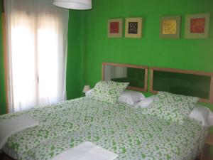锡古恩萨Casa La Alegria De La Alcarria II的绿色卧室,配有床和绿色的墙壁