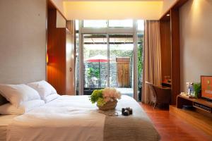 鹿野鹿鸣温泉酒店的卧室配有白色的床和花瓶