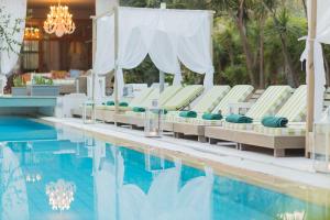 斯基亚索斯镇游泳池艺术酒店，菲莲酒店及度假村的一组躺椅,位于游泳池旁