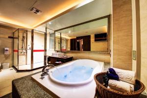 台南温莎堡汽车旅馆 - 仁德馆的一间带浴缸和大镜子的浴室