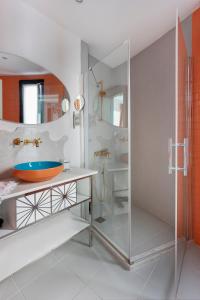 切什梅萨托设计酒店的一间带玻璃淋浴和水槽的浴室