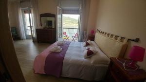 萨莱马拉西诺阿尔博格莫塔酒店的一间卧室配有一张大床和毛巾