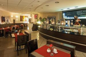 温德哈根风之4号餐厅酒店的一间带桌椅的餐厅和一间酒吧