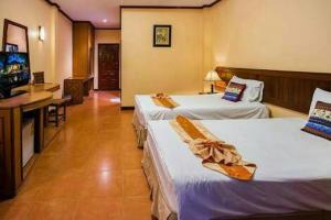 美索Baan Kiang Chan Resort的酒店客房设有两张床和一台平面电视。