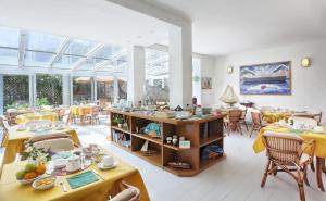马西亚娜马里纳游艇俱乐部酒店的用餐室设有桌椅和窗户。