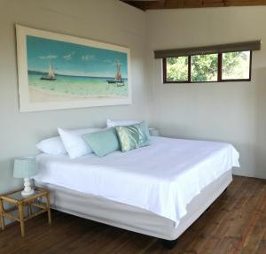 索德瓦纳湾Dune View Cottage的一间卧室配有一张带白色床单的床和一扇窗户。