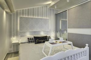 普拉Apartments Zanetti 2的卧室配有白色的床和桌子